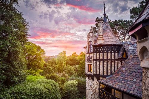 an old building with a tower in the woods at Thorngrove Manor in Stirling