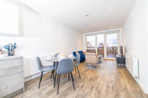 a kitchen and dining room with a table and chairs at City Escape - Unwind in Style in Barking