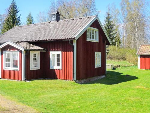 a red house with white windows in a yard at 6 person holiday home in TINGSRYD-By Traum in Tingsryd