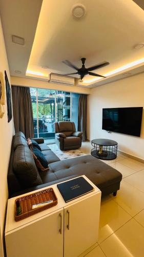 a living room with a couch and a flat screen tv at The DreamHouse Homestay in Lahad Datu