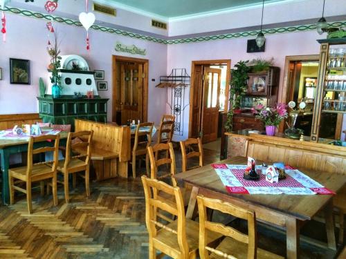 a dining room with wooden tables and chairs at Gasthof Redl in Oed