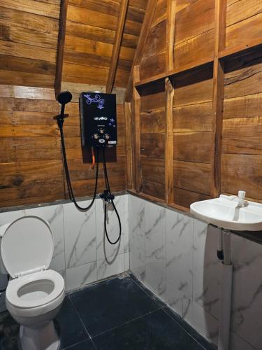a bathroom with a toilet and a sink at Luxury Wooden House 