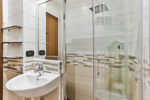 a bathroom with a sink and a shower at Hotel Avana Mare in Rimini
