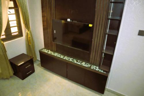 a large entertainment center with a flat screen tv at Luxury Charming 5Bed Duplex With Starlink wifi - Lekki in Ikota
