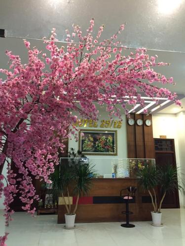 a tree with pink flowers in a building at Khách sạn 25 tháng 12 - Tánh Linh in Tánh Linh