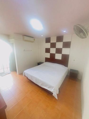 a bedroom with a bed with a checkered wall at T&R Wagner Appartaments in Patong Beach