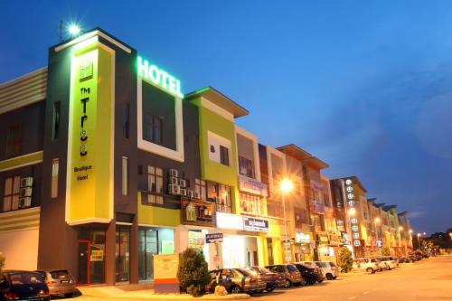 a row of buildings on a street at night at The Tree Boutique Hotel in Shah Alam
