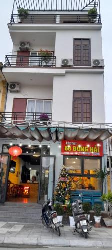 un edificio con un árbol de Navidad delante de él en Khách sạn 68 ĐỒNG HẢI, en Dong Hoi