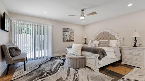 a bedroom with a bed and a chair and a window at Luxe Central Scottsdale 4 bdrm w Backyard Oasis in Scottsdale