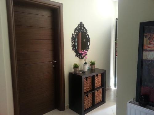 a room with a door and a table with a mirror at Villa Anna Maria in Kriopigi