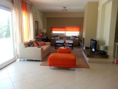 a living room with a couch and a table at Villa Anna Maria in Kriopigi