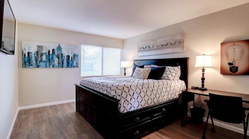 a bedroom with a bed and a desk and a window at Comfy 1-Bdrm Condo in Heart of Old Town Scottsdale in Scottsdale