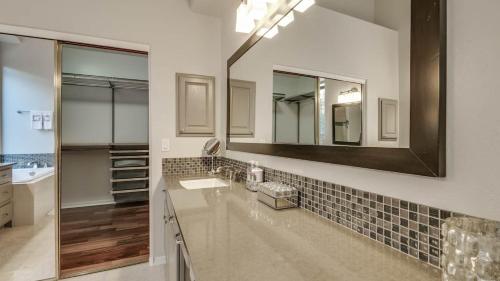 a bathroom with a sink and a mirror at North Scottsdale Sanctuary w Htd Pool and Views in Scottsdale