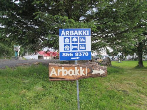 a sign that is on the side of a road at Árbakki Farmhouse Lodge in Reykholt