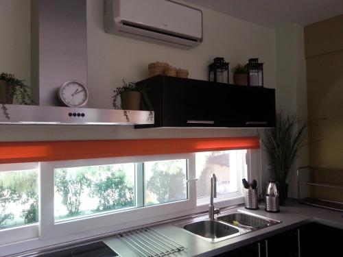 a kitchen with a sink and a window at Villa Anna Maria in Kriopigi