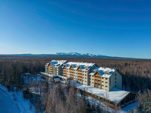 an aerial view of a resort in the snow at DoubleTree by Hilton Changbaishan Hot Spring in Antu