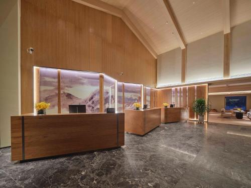 a lobby with a reception desk in a building at DoubleTree by Hilton Changbaishan Hot Spring in Antu