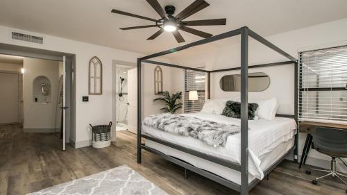 a bedroom with a canopy bed and a desk at Newly Renovated 4 Bedroom Retreat wPool in Phoenix