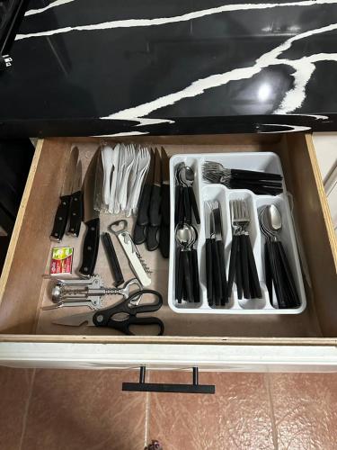 a drawer filled with lots of utensils at Eagles Nest Villa House AC TV WIFI Fan Luxury Modern in Albion