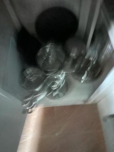a group of glass dishes sitting on a shelf at Eagles Nest Villa House AC TV WIFI Fan Luxury Modern in Albion