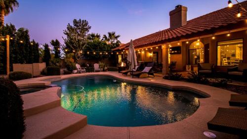 a swimming pool in front of a house at Luxury N. Scottsdale Home wPrivate Oasis Yard in Phoenix