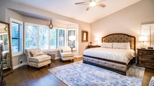 a bedroom with a bed and a chair and windows at Stunning North Scottsdale Luxury Home wHTD Pool in Phoenix