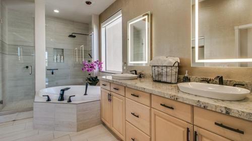 a bathroom with two sinks and a tub and a shower at Fabulous 4-Bdrm WBreathtaking Views & Pool in Fountain Hills