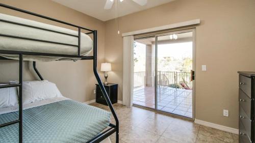 a bedroom with a bunk bed and a balcony at Fabulous 4-Bdrm WBreathtaking Views & Pool in Fountain Hills