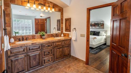 a bathroom with two sinks and a large mirror at Entertainers Dream in Scottsdale wPool and Games in Phoenix