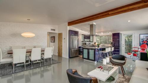 a kitchen and living room with a table and chairs at Mid-Century Modern wBackyard Oasis Putting Green in Phoenix