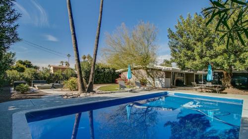 a swimming pool in front of a house at Mid-Century Modern wBackyard Oasis Putting Green in Phoenix