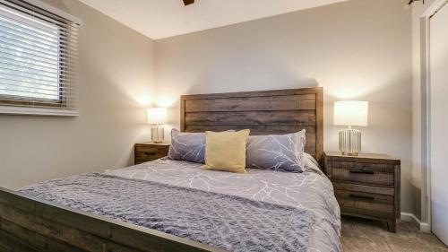 a bedroom with a bed with two night stands and two lamps at Remodeled Tempe Home in Prime Location in Tempe