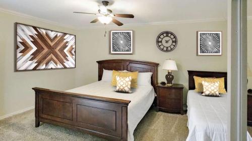 a bedroom with two beds and a ceiling fan at The Palm in Scottsdale