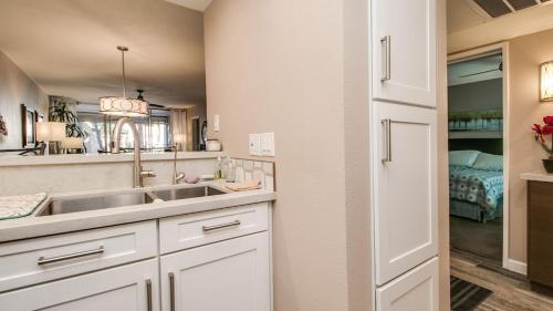 a kitchen with a sink and a bedroom at Cozy 2-Bdrm Condo in Heart of Old Town Scottsdale in Scottsdale