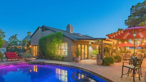 a home with a swimming pool in front of a house at Scottsdale Gem wPool in Private and Serene Yard in Scottsdale