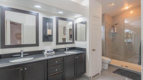 a bathroom with two sinks and a shower at Scottsdale Gem wPool in Private and Serene Yard in Scottsdale