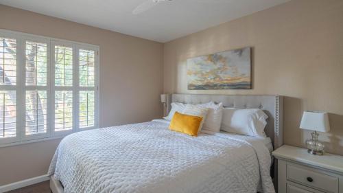 a bedroom with a bed with a yellow pillow on it at Scottsdale Gem wPool in Private and Serene Yard in Scottsdale