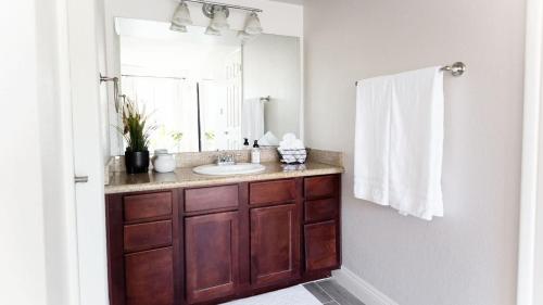 a bathroom with a sink and a mirror at Stylish Old Town 2 bdrm ground floor Condo in Scottsdale