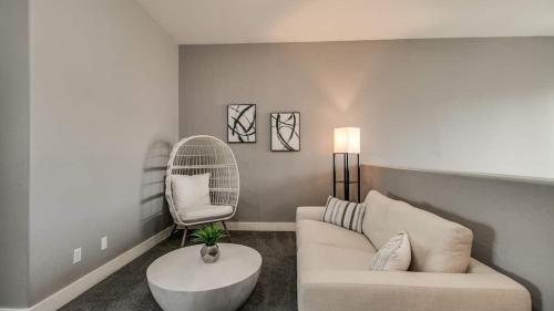 a living room with a white couch and a chair at 3 Bdrm Townhouse WGarage in Gated Complex in Phoenix
