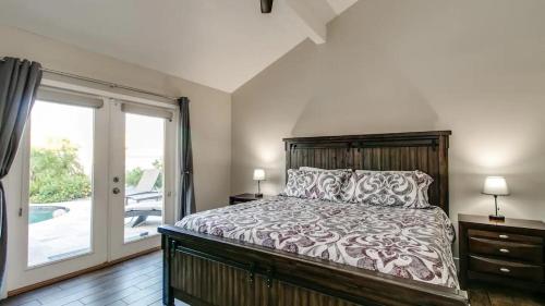 a bedroom with a bed and a sliding glass door at Spectacular Hilltop Home wResort Like Backyard in Fountain Hills