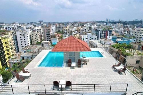a view of a pool on top of a building at Cozy Studio Apartment Basundhara in Dhaka