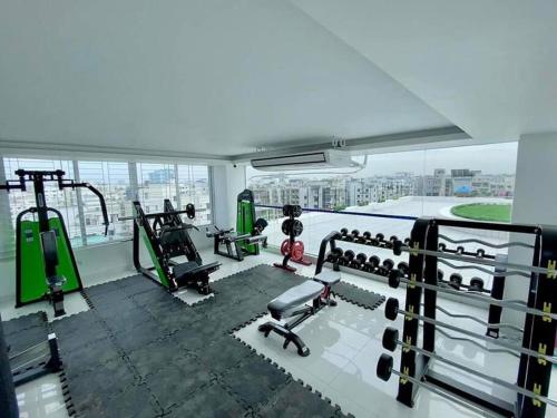 a gym with fitness equipment in a building at Cozy Studio Apartment Basundhara in Dhaka