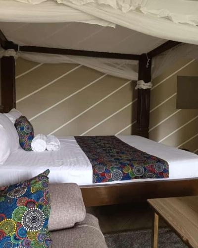 a couple of bunk beds in a room with a couch at LOFTY DIANI STUDIO'S in Kwale