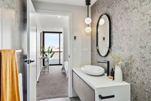 a bathroom with a sink and a mirror at Hobart CBD Roof Top Penthouse in Hobart