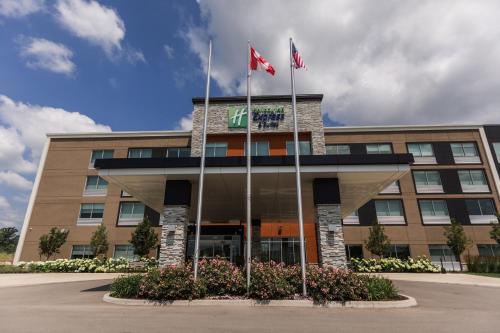 a building with two flags in front of it at Holiday Inn Express & Suites - Welland in Welland