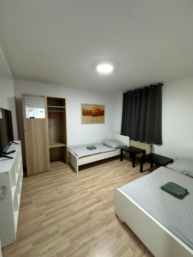 a large room with two beds and a table at Schön gelegene Apartments im Zentrum in Mönchengladbach MG07 und MG10 in Mönchengladbach