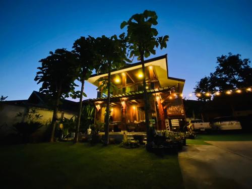 a building with lights on it at night at 188 Teak House บ้านต้นสัก in Chiang Mai