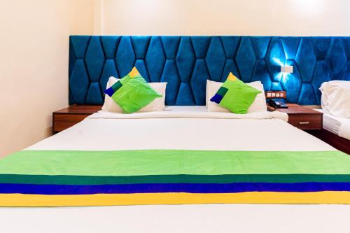 a bedroom with a large white bed with colorful pillows at Treebo Express Inn in Mumbai