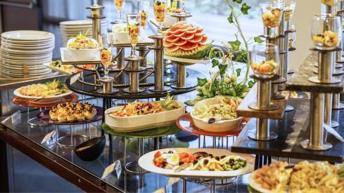 a buffet with many plates of food on display at Crowne Plaza Amman by IHG in Amman