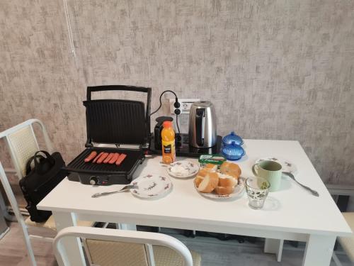 a white table with a laptop on top of it at Eminera Hostels Baku in Baku